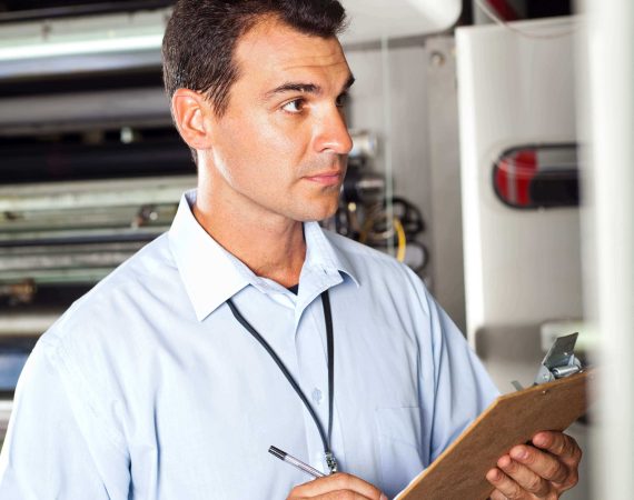 industrial technician taking machine readings